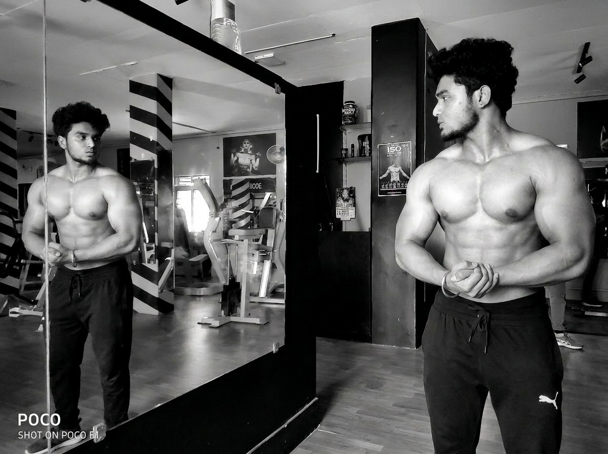 Muscular athlete posing in gym
